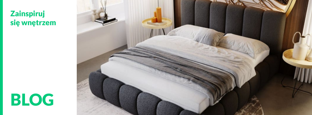Ł&oacute;żko tapicerowane w ciemnej, puszystej tkaninie z podłużnym wezgłowiem w nowoczesnej sypialni.